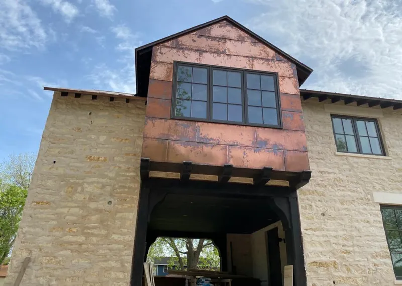 Copper metal panel facade on a stone building for Skylight Installation in Richfield